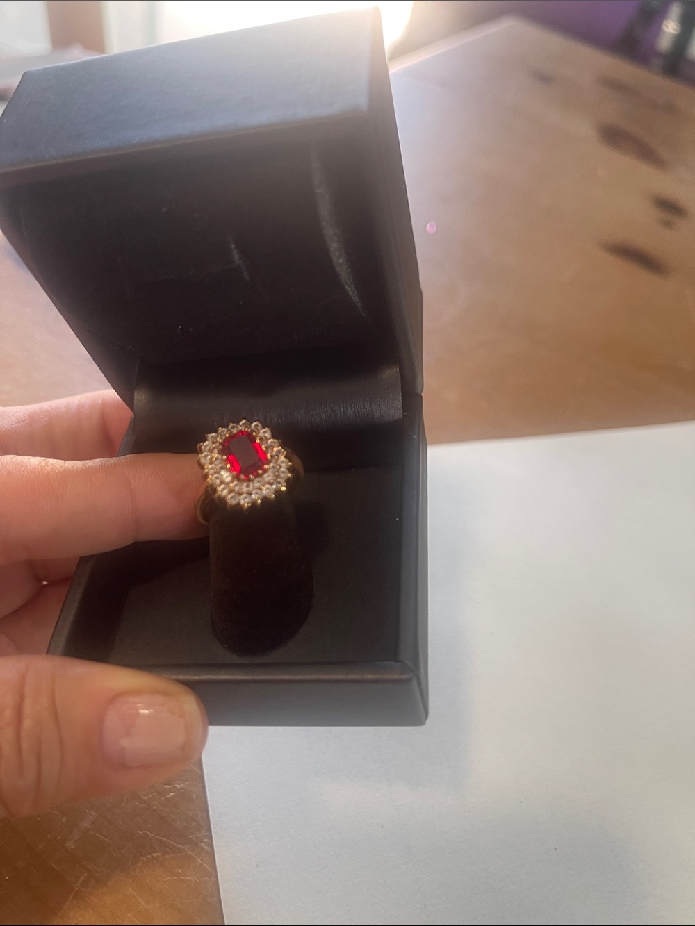 Gold-Tone Ring with Deep Red Center Stone and Halo Accent